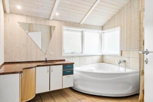 a bathroom with a large tub and a sink at 80608-Vemb-Knudehus-51 in Vemb