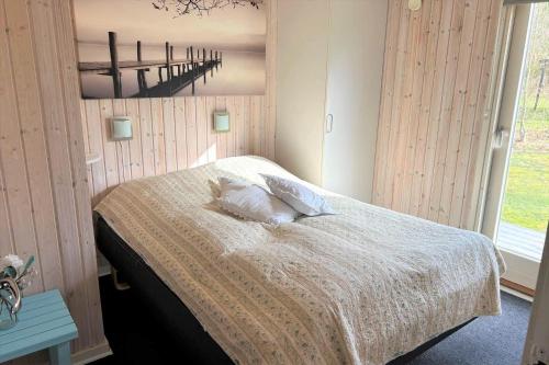 a bedroom with a bed with two pillows on it at 30826-Ulfborg-Klovervej-480 in Ulfborg