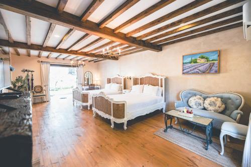 a bedroom with two beds and a couch at Moon River Village in Ban Bu Khanun