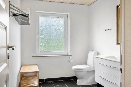 a bathroom with a toilet and a window at 80057-Ulfborg-Rolighedsvej-3 in Ulfborg