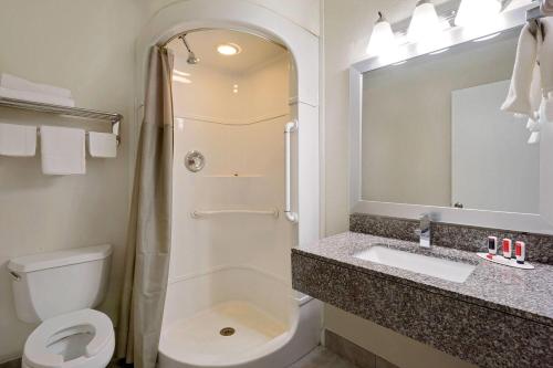 a bathroom with a toilet and a sink and a shower at Super 8 by Wyndham Florence in Florence
