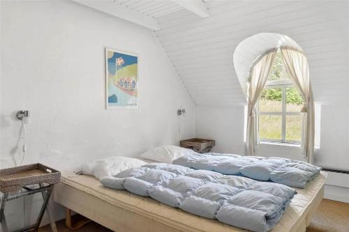 a large bed in a room with a window at 10616-Ulfborg-Vester-Mosevej-28 in Ulfborg