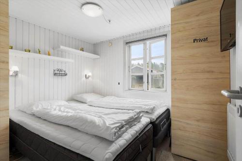a bedroom with two beds and a window at 30185-Ulfborg-Bellisvej-509 in Ulfborg