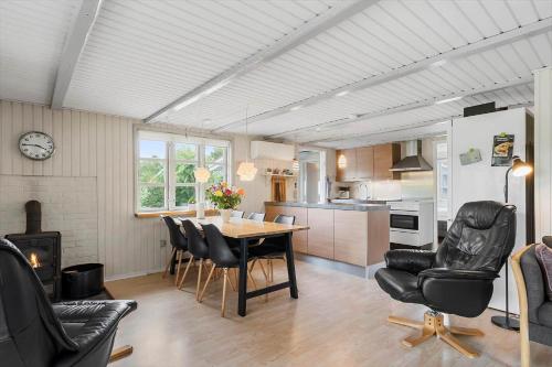 a kitchen and dining room with a table and chairs at 30185-Ulfborg-Bellisvej-509 in Ulfborg