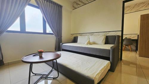 a hotel room with two beds and a table at Setia Alam Edu Sentral # JSA Walking Distance # Setia Convention Centre & Setia City Mall in Setia Alam