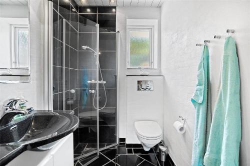 a bathroom with a shower and a sink and a toilet at 20220-Ulfborg-Sundhuse-13 in Ulfborg