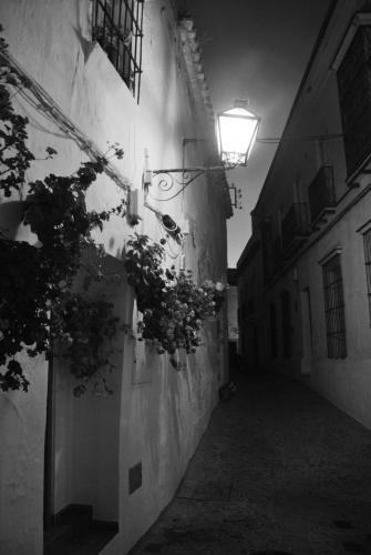 an alley with a light on the side of a building at Pensión San Marcos in Arcos de la Frontera
