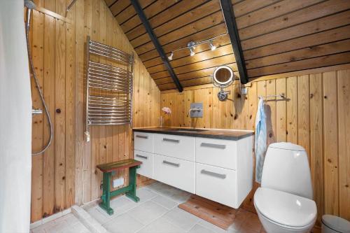 a wooden bathroom with a toilet and a shower at 80179-Vemb-Harpotvej-74 in Vemb