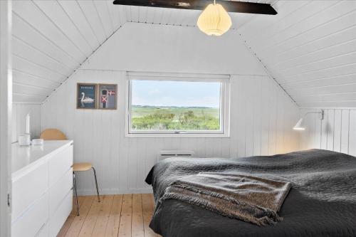 a white bedroom with a bed and a window at 20041-Ulfborg-Knakvej-10 in Ulfborg