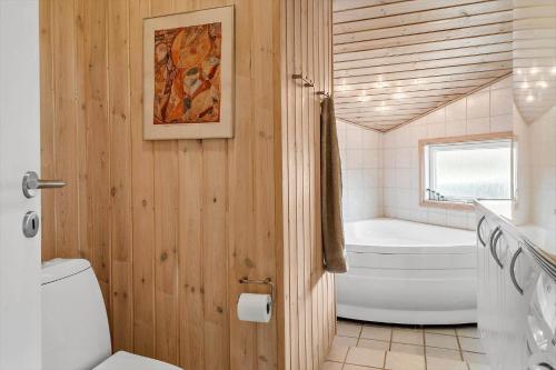 a bathroom with a toilet and a bath tub at 30872-Ulfborg-Bellisvej-514 in Ulfborg
