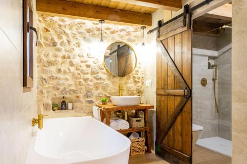 a bathroom with a white toilet and a sink at Refugi dels Somnis - Turismo con encanto en Onda in Onda
