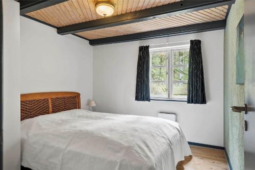 a bedroom with a bed and a window at 10755-Ulfborg-Kjaergaardvej-20 in Ulfborg
