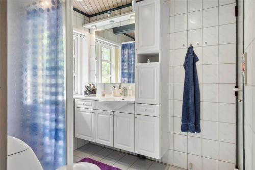 a bathroom with a sink and a mirror at 10755-Ulfborg-Kjaergaardvej-20 in Ulfborg