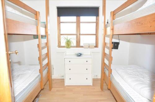 a bedroom with two bunk beds and a window at 20038-Ulfborg-Knakvej-8 in Ulfborg
