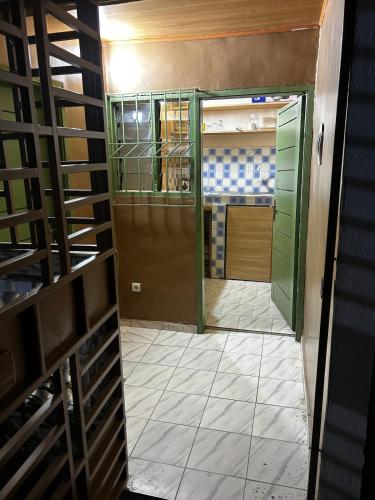 a room with a door and a tile floor at Studio spacieux Aéroport FHB in Abidjan