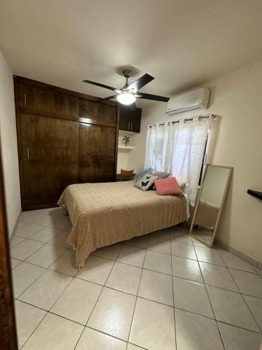 a bedroom with a bed and a ceiling fan at Casita Océano in La Paz