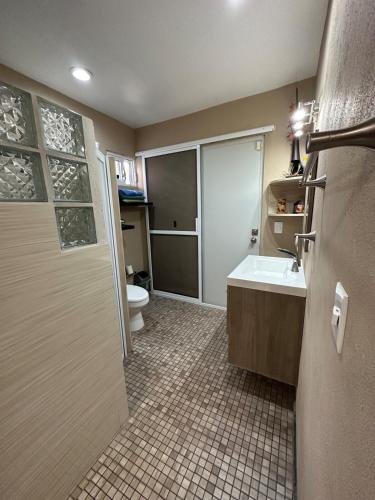 a bathroom with a shower and a sink and a toilet at Casita Océano in La Paz