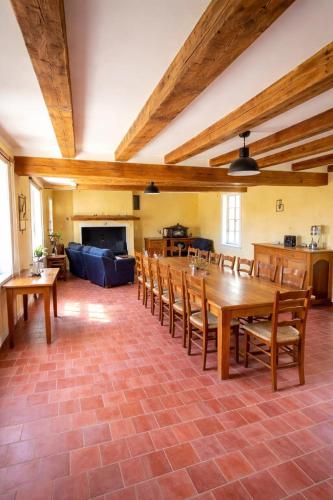 a large room with a large wooden table and chairs at La longère du golf in Verneuil-sur-Indre