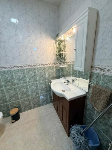 a bathroom with a sink and a mirror at Casa Pumba in San Martín de la Vega