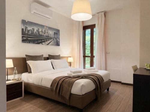 a bedroom with a large bed and a large window at Cameracaffè sul Lago in Arezzo