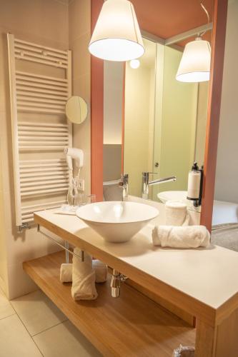 a bathroom with a sink and a large mirror at Hotel Balneario Prats in Caldes de Malavella