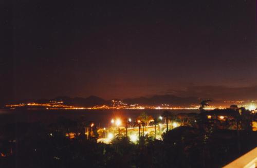 a view of a city at night with lights at Apartment Montmorency in Cannes