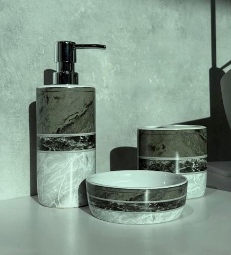 a soap dispenser and a bottle on a table at Dreams Hotel in Gjirokastër
