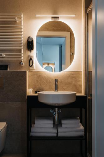 a bathroom with a sink and a mirror at Hotel M4 Boutique in Krakow