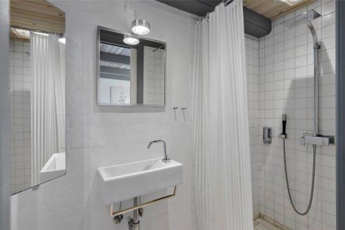 a white bathroom with a sink and a shower at 20132-Ulfborg-Tyttebaervej-19 in Ulfborg