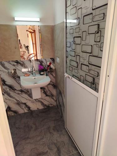 a bathroom with a sink and a mirror at Robert Ayurveda Villa in Bentota