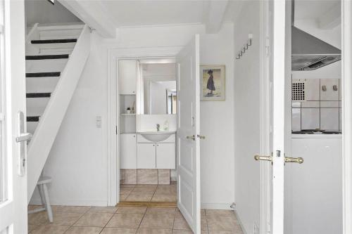 a white bathroom with a sink and a staircase at 70240-Ulfborg-Vesterhavsgade-12 in Ulfborg