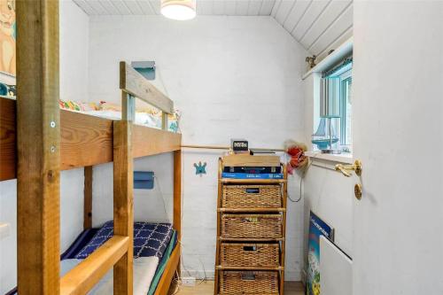 a bunk bed room with two bunk beds and a ladder at 30327-Ulfborg-Grastensborgvej-38 in Ulfborg