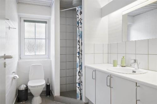 a white bathroom with a toilet and a sink at 10607-Ulfborg-Gaffelbjergvej-38 in Ulfborg