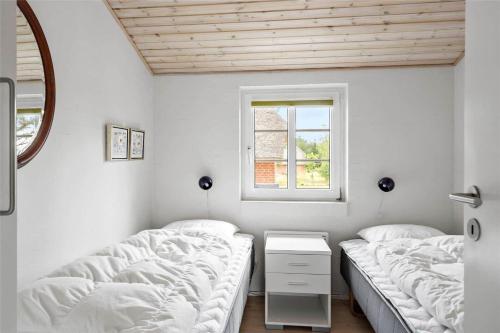 a bedroom with two beds and a window at 20733-Ulfborg-Sortebaervej-4 in Ulfborg