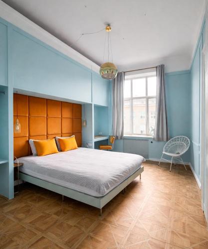 a bedroom with a large bed with blue walls at 4th Floor Bed and Breakfast in Warsaw
