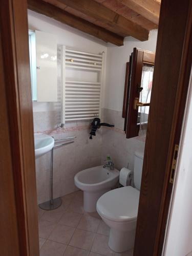 a bathroom with a toilet and a sink at Casina Luce in Stiava