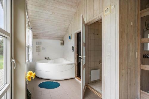a bathroom with a white tub in a room at 30705-Ulfborg-Valmuevej-288 in Ulfborg