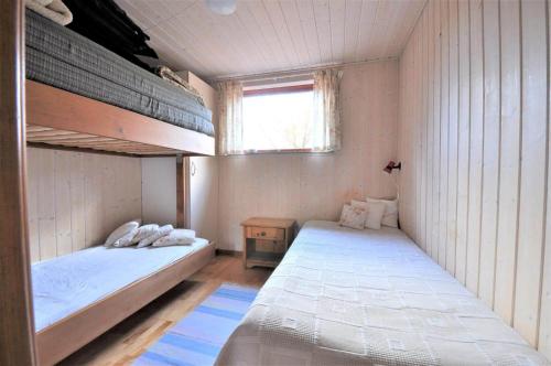 a bedroom with two bunk beds and a window at 30061-Ulfborg-Kaprifolievej-6 in Ulfborg