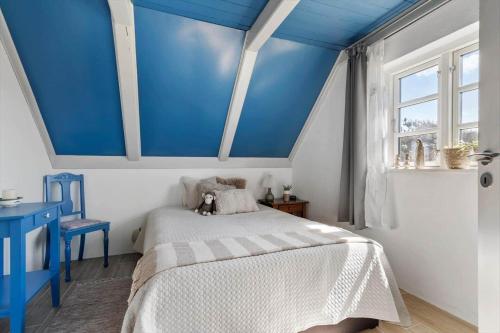 a bedroom with a blue ceiling with a bed and a window at 20157-Ulfborg-Revlingvej-8 in Ulfborg