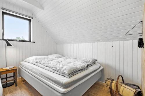 a bed in a white room with a window at 20356-Ulfborg-Lars-Murersvej-9 in Ulfborg