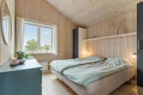 a bedroom with a bed and a desk and a window at 60836-Ulfborg-Fjand-Strand-29 in Ulfborg