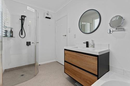 a bathroom with a sink and a mirror at Roslyn Sanctuary Highgate Dunedin in Dunedin