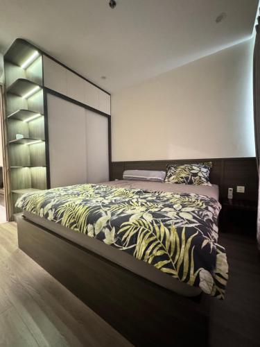 a bedroom with a large bed with a zebra blanket at VHGP-Bs10 in Long Bình