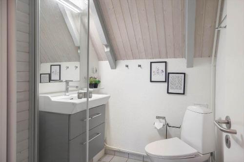 a bathroom with a toilet and a sink at 20362-Ulfborg-Sortebaervej-22 in Ulfborg