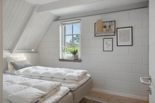 a room with two white pillows on a bed at 20362-Ulfborg-Sortebaervej-22 in Ulfborg