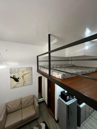 a room with two bunk beds and a couch at KMRP Condo Unit in Baguio