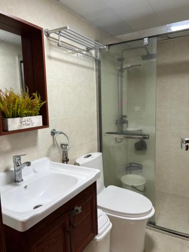 a bathroom with a sink and a toilet and a shower at KMRP Condo Unit in Baguio