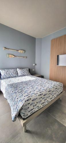 a bedroom with a large bed with a blue wall at Casa Ilenia Clusane d'Iseo in Clusane sul Lago