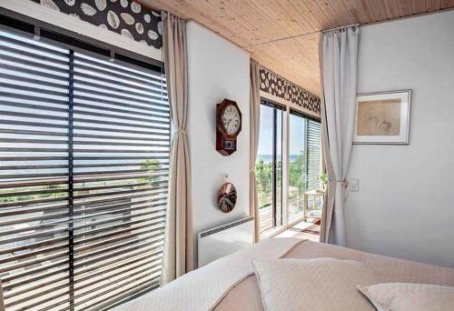 a bedroom with a bed and a clock on the wall at SL324-Slagelse-Strandvaenget-29 in Slagelse