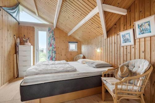 a bedroom with a bed and a chair and a window at SL308-Slagelse-Jarlsvej-23 in Slagelse